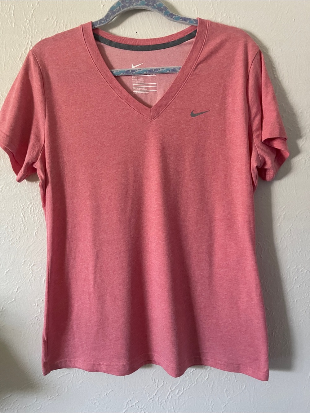 Nike Women's  V-Neck T-Shirt. Color is mixture of pink/peach